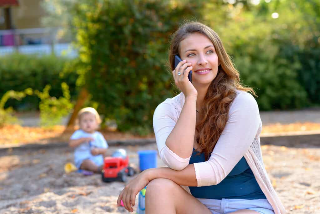 Attractive young mother talking on her mobile